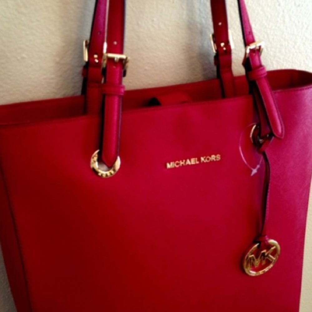 michael kors jet set travel tote. Will fit a laptop.